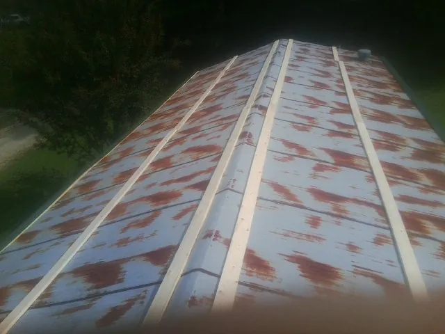 Rusted metal roof panels with new wood purlins before replacement — Storm Damage Roof Repair in Frackville by Roofing Brothers