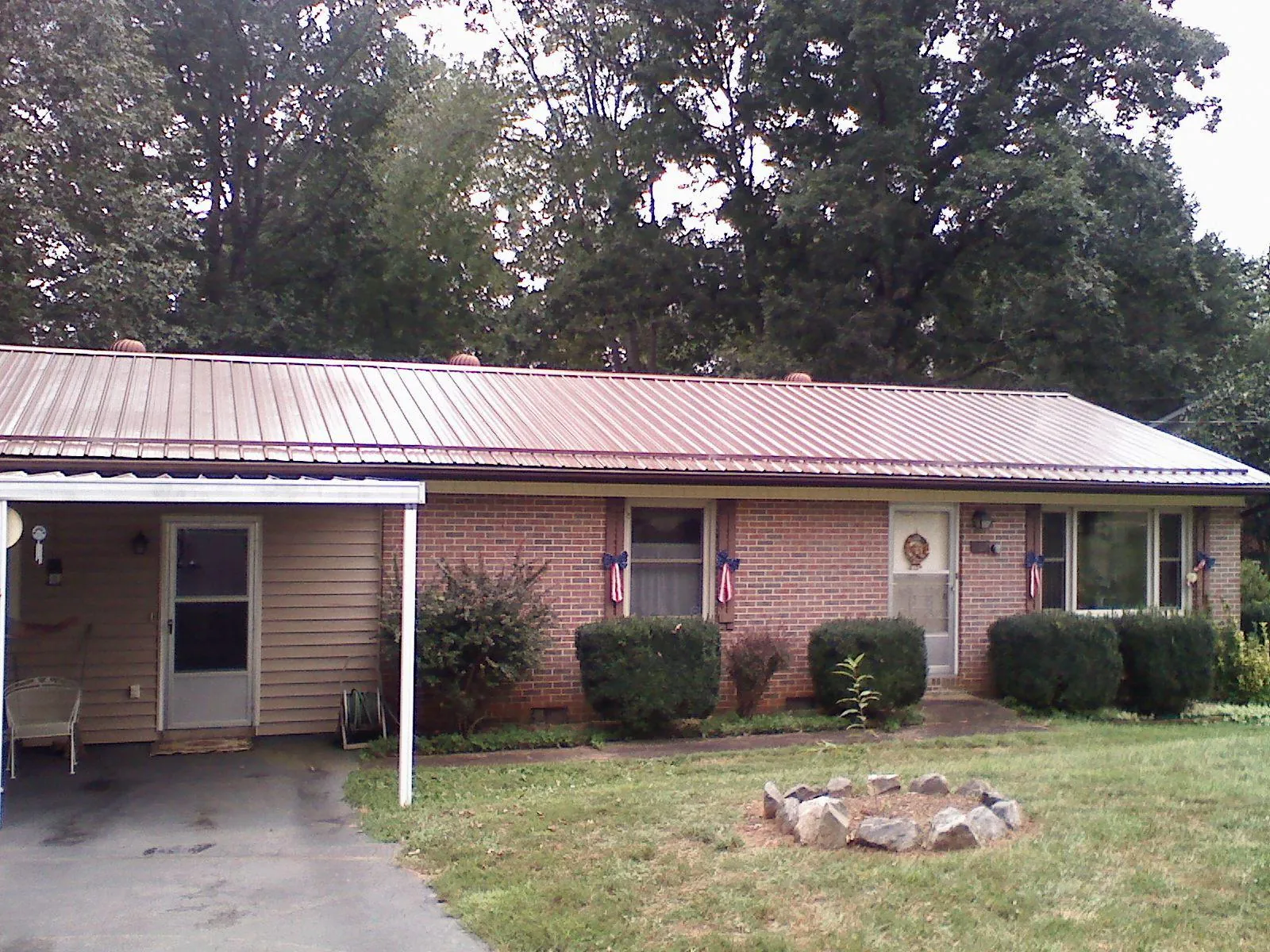 Bronze metal roof and carport on a brick ranch home — Roof Repair work by our crew in Frackville