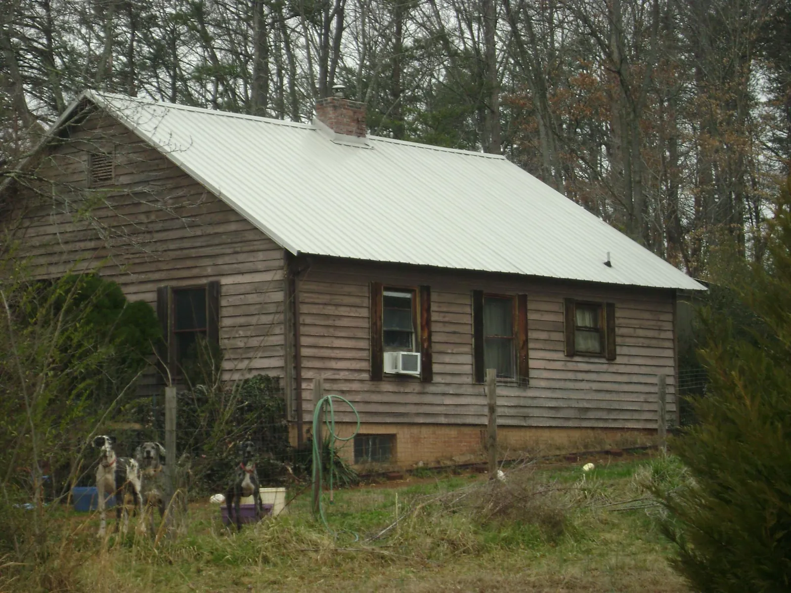 White metal roof on an old wood sided farmhouse, from a Metal Roof Installation job in Frackville